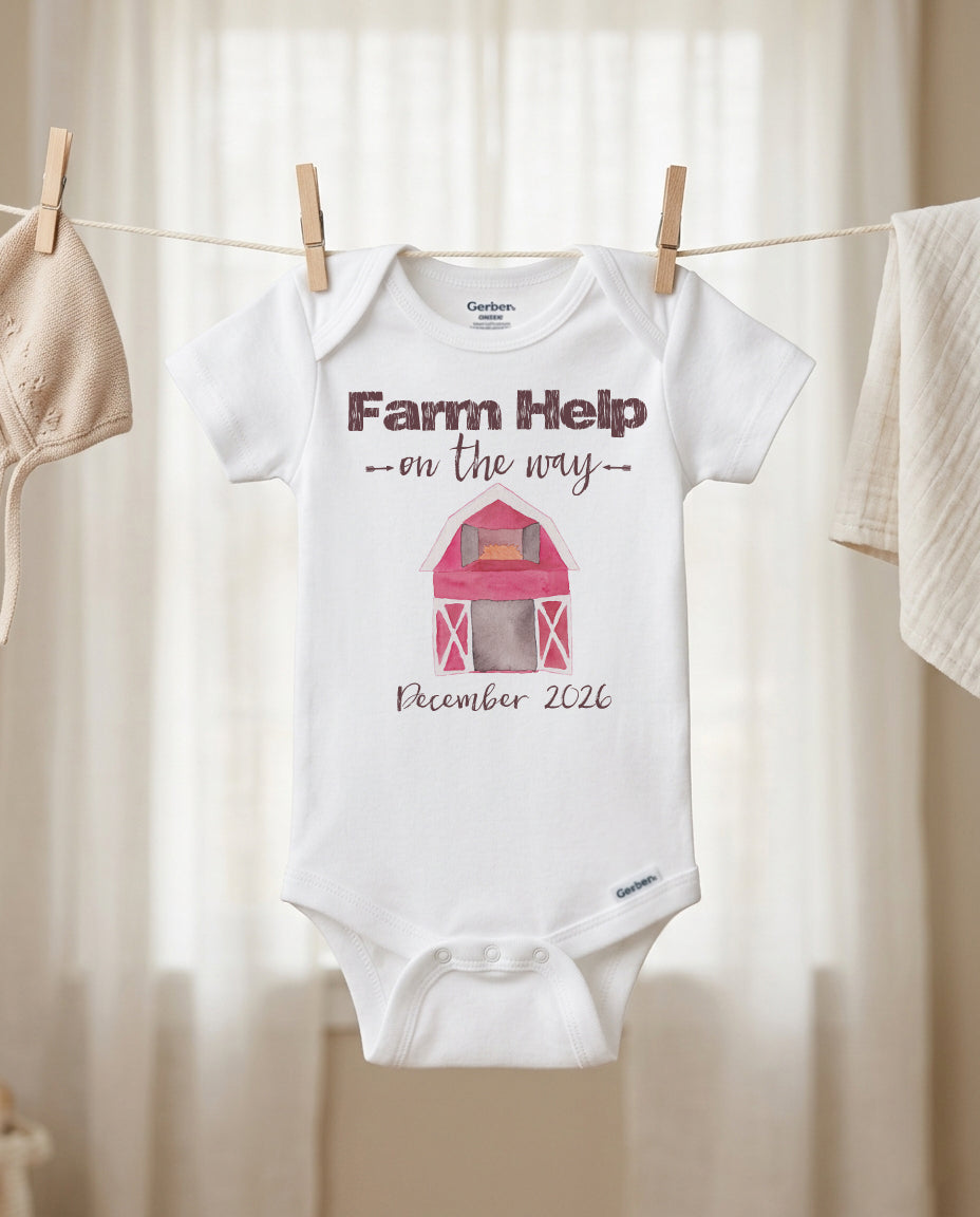 Baby onesie with 'Farm Help on the way' text and barn graphic, hanging on a clothesline.
