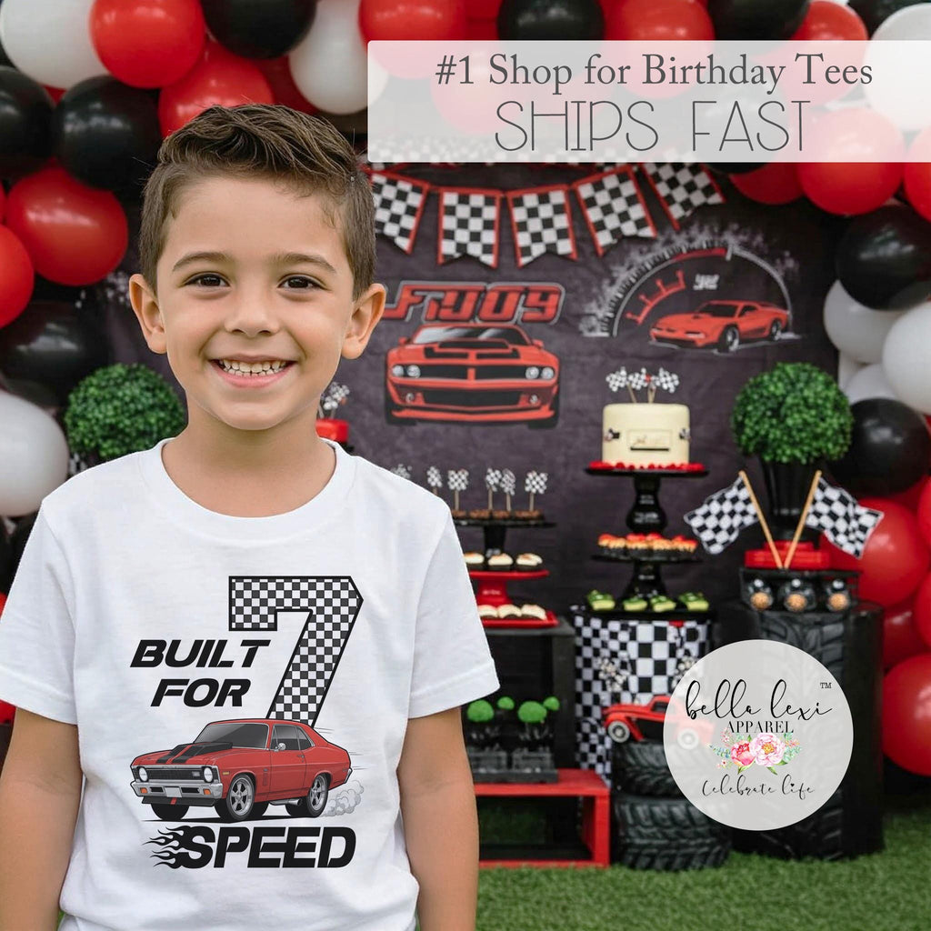 7-year-old boy wearing a white "Built for Speed" birthday shirt at a race car themed party with red, black, and white decorations.