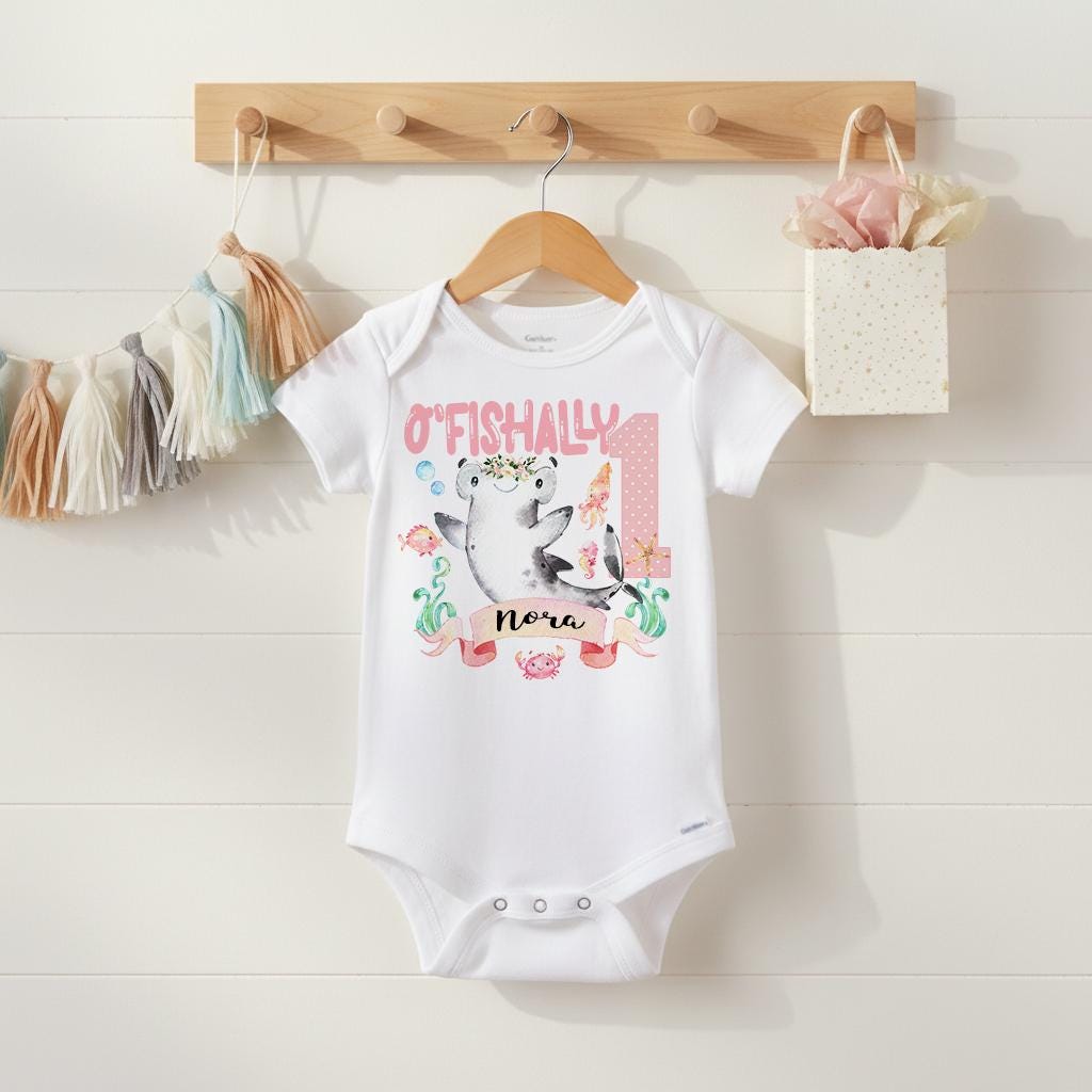 Under the Sea theme First Birthday Onesie®.  Such a CUTE first birthday bodysuit or t-shirt for your little girl!  It features a variety of watercolor sea creatures and your little one's name.  "O'Fishally 1"!  Since all of Bella Lexi™ designs are printed directly into the garments of your choice, the designs won't peel, crack or fade!  This under the sea theme birthday design also makes a wonderful gift!  Your little one will look adorable for her special day!