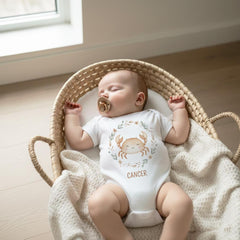 Cancer zodiac baby onesie featuring a soft boho watercolor design on a bright white background. Unisex astrology baby outfit perfect for June and July birthdays, newborn photos, baby shower gifts, horoscope-themed milestone pictures, and gender-neutral baby clothing. High-quality printable Cancer zodiac artwork for infant apparel