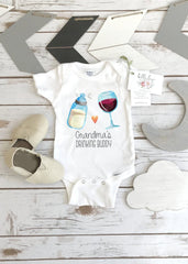 May include: A white baby onesie with a graphic of a baby bottle and a glass of wine. The text on the onesie reads 'Grandma's Drinking Buddy'.