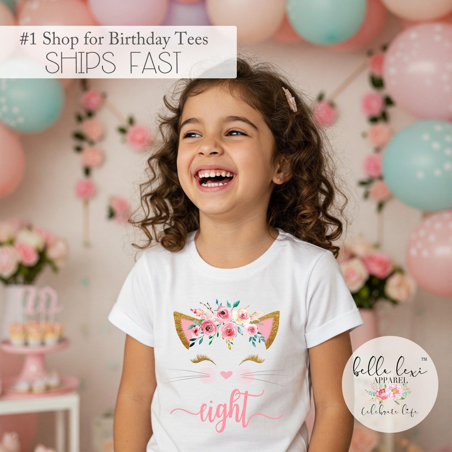 May include: A white t-shirt with a pink and gold cat design and the word "eight" in pink. The girl wearing the shirt is smiling and surrounded by pink and blue balloons.