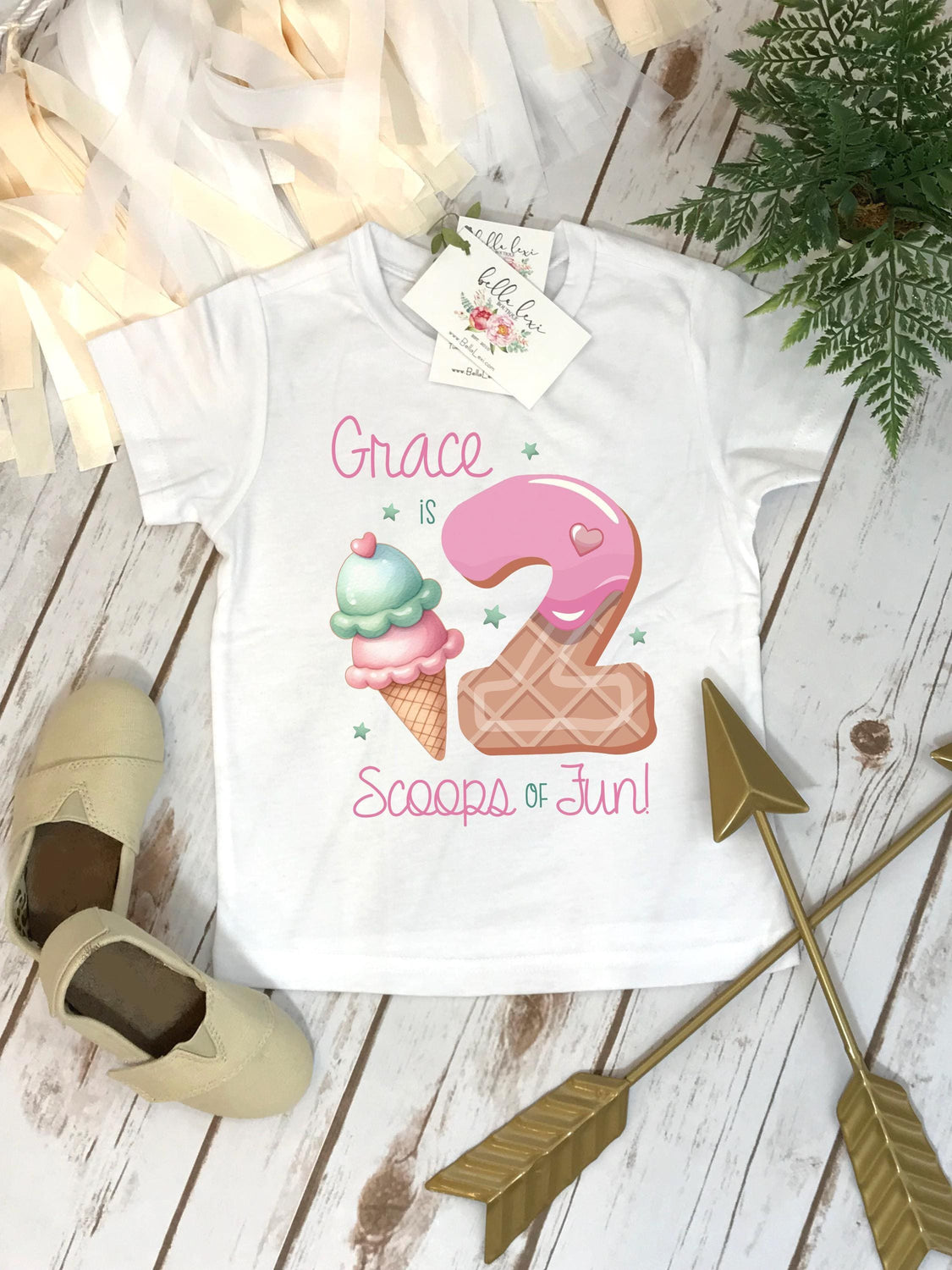 May include: White t-shirt with a pink and white ice cream cone and a pink donut with a pink heart on top. The text "Grace is 2 Scoops of Fun!" is printed on the shirt.