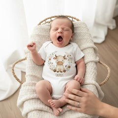 Taurus zodiac baby onesie with a soft boho watercolor design on a bright white background. Unisex astrology baby outfit perfect for April and May birthdays, newborn photos, baby shower gifts, horoscope-themed milestone pictures, and gender-neutral baby clothing. High-quality printable Taurus zodiac artwork for infant apparel.