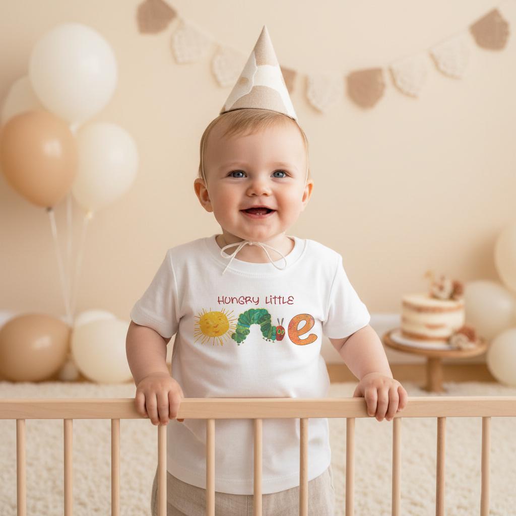 "Hungry Little One "  Celebrate your little one's first birthday with this cute caterpillar-themed onesie. Perfect for a day full of colorful fun, this design will make your baby the most charming little crawler at the party!