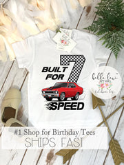 White short sleeve kids t-shirt flat lay with "Built for Speed" design, displayed on a white background for a race car 7th birthday theme.