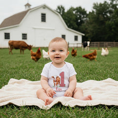 May include: A white short-sleeved baby bodysuit featuring a graphic of a brown calf standing next to a large red and white checkered number one. The name Ean is printed in red cursive script below the calf on the front of the garment.
