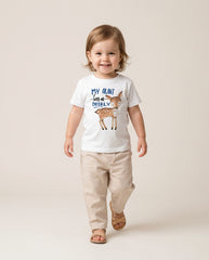 Child wearing a t-shirt with a deer graphic and text, standing against a plain background